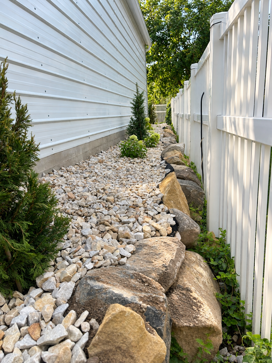 Decorative rock, boulders, and planting in a residential landscape