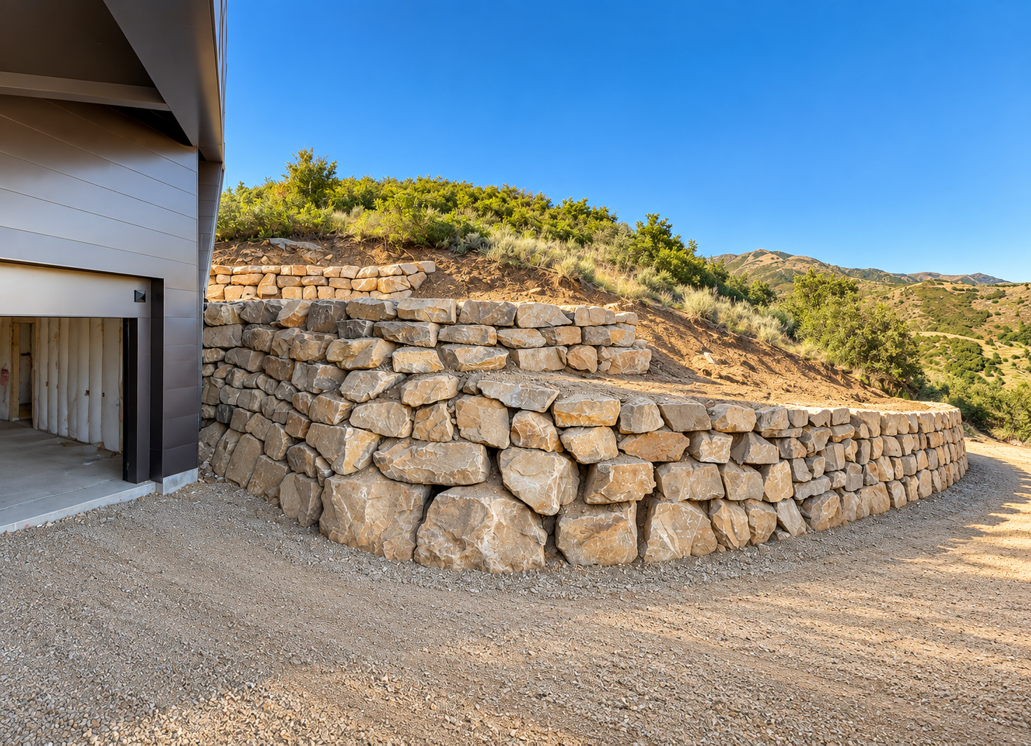 Terraced stone retaining wall beside a hillside home